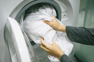 Woman removing laundry from washing machine