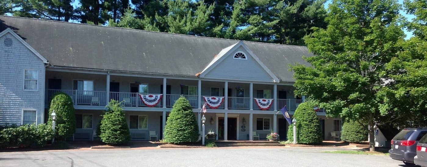 Exterior view of establishment with red white and blue banners hanging from banisters. .