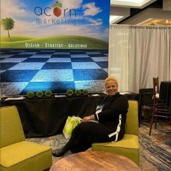 Beautiful woman sitting in a green chair at a conference.