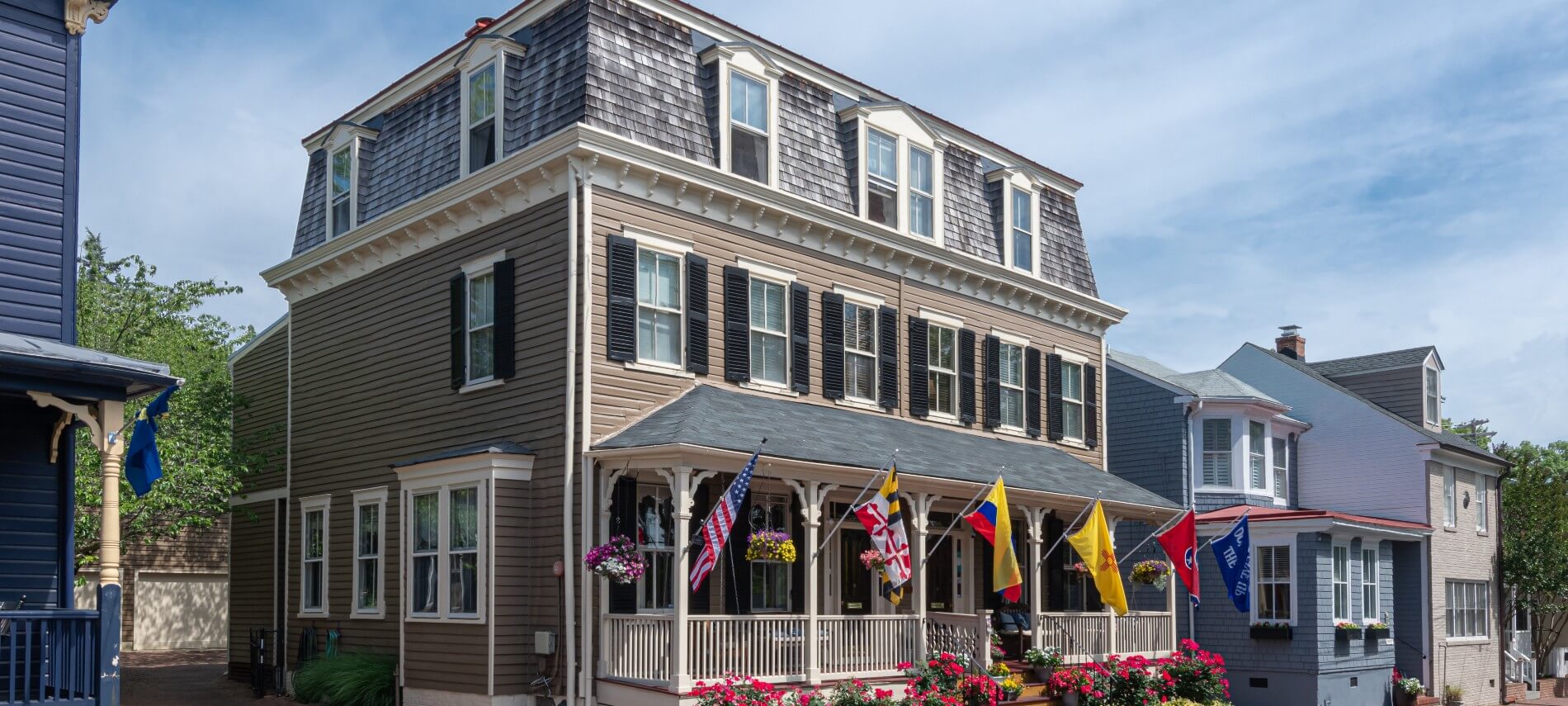large house, porch, windows, flags