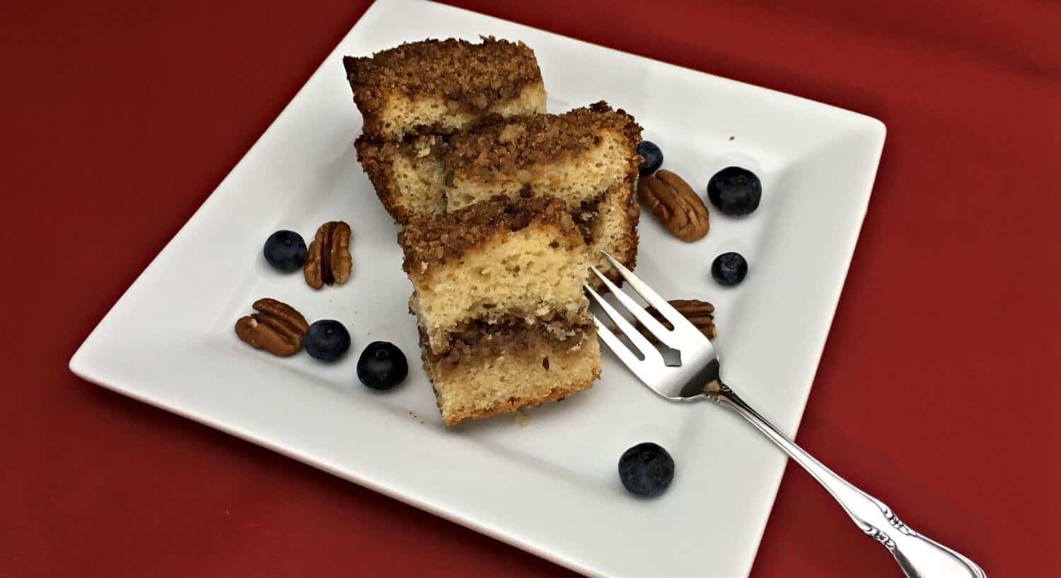 Coffee cake on a white plate with a fork 