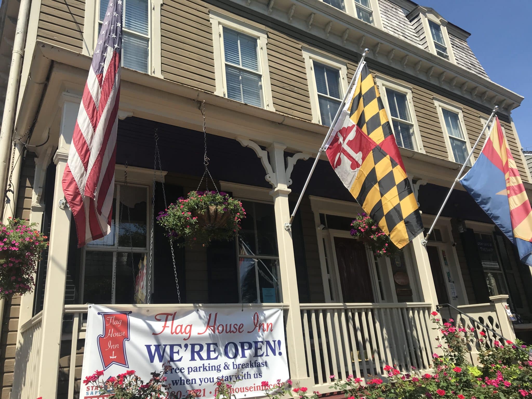 Front of Inn with flags flying from the porch
