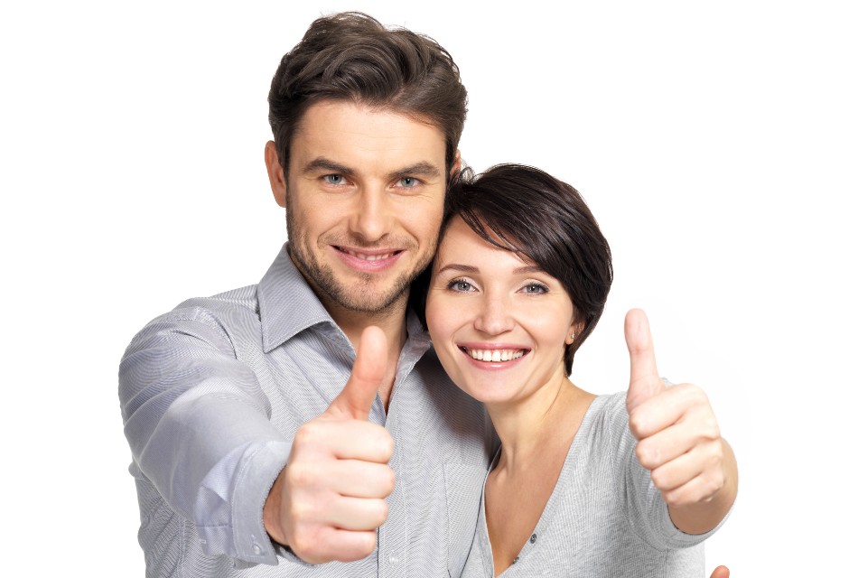 Good looking happy brunette couple smiling at camera with thumbs up