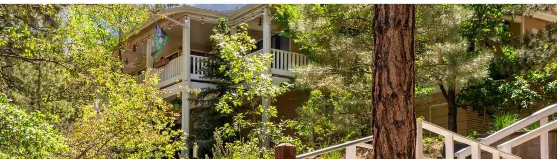 Multi-story inn set among trees with staircases outdoors - The Sheridan House Inn, Williams, AZ